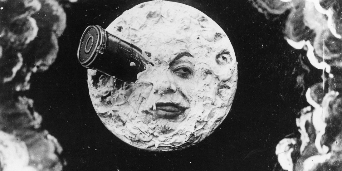 A classic scene from the silent film A Trip to the Moon (1902), showing a rocket embedded in the anthropomorphic face of the moon